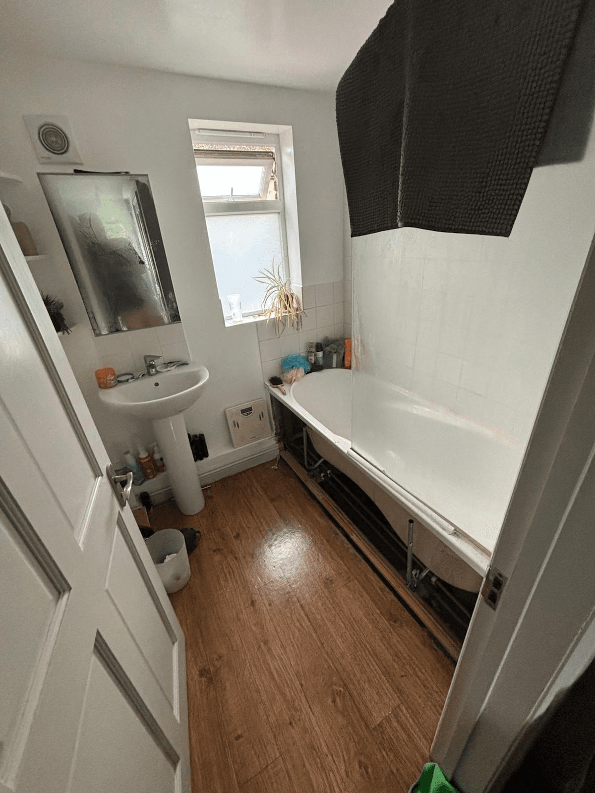 Bathroom before refurbishment — old suite and flooring