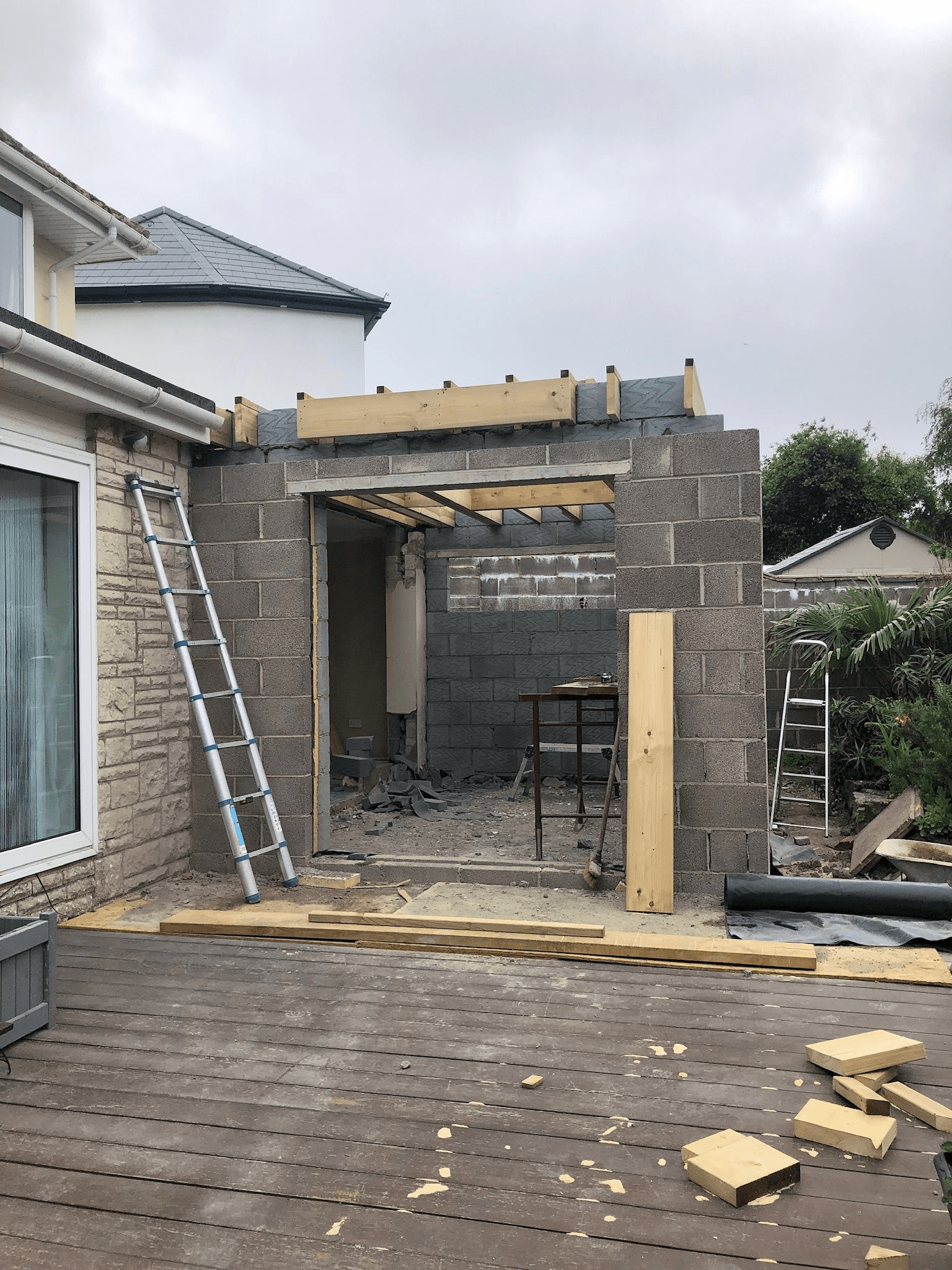 Extension under construction — blockwork walls and roof structure