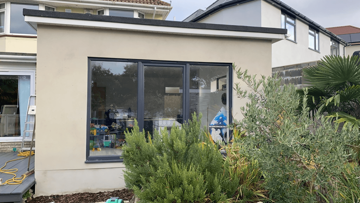 Rendered single-storey extension with large aluminium windows