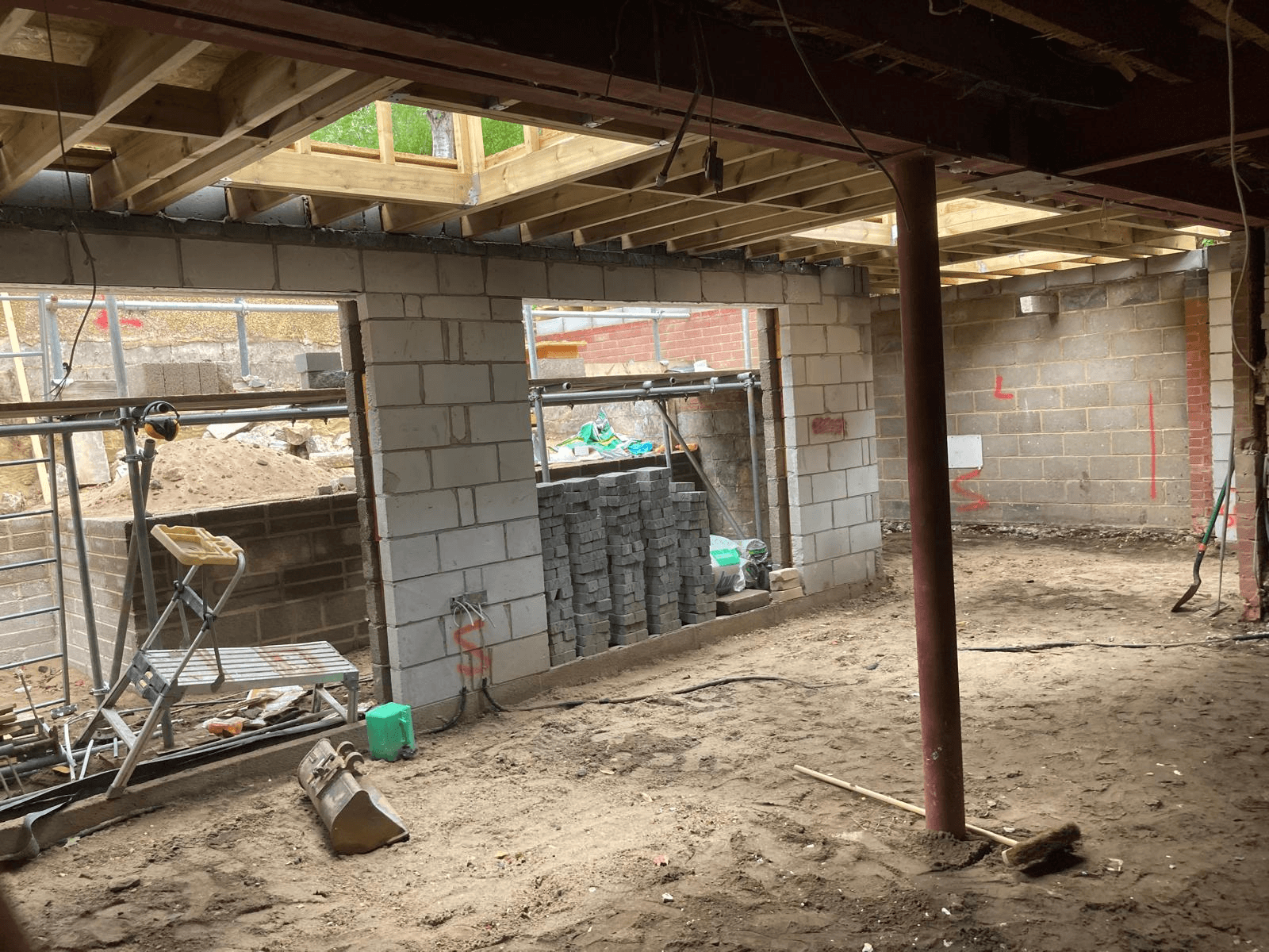 Extension under construction — blockwork walls, steel column and roof structure