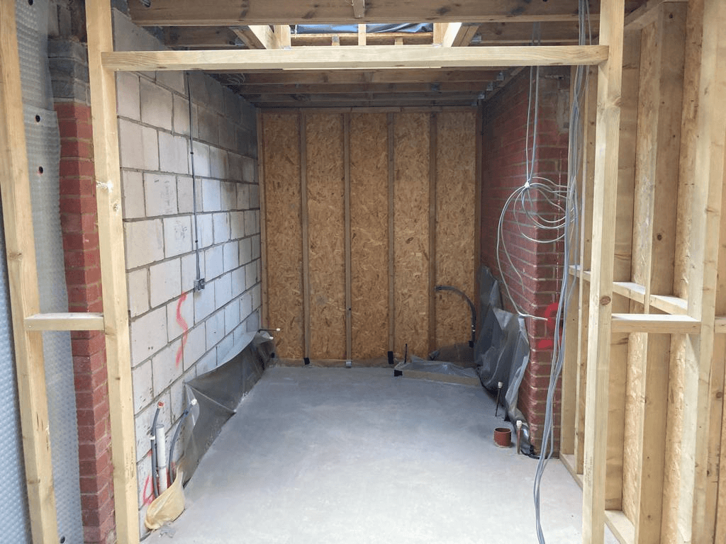 Extension under construction — timber stud frame with insulation and first fix wiring