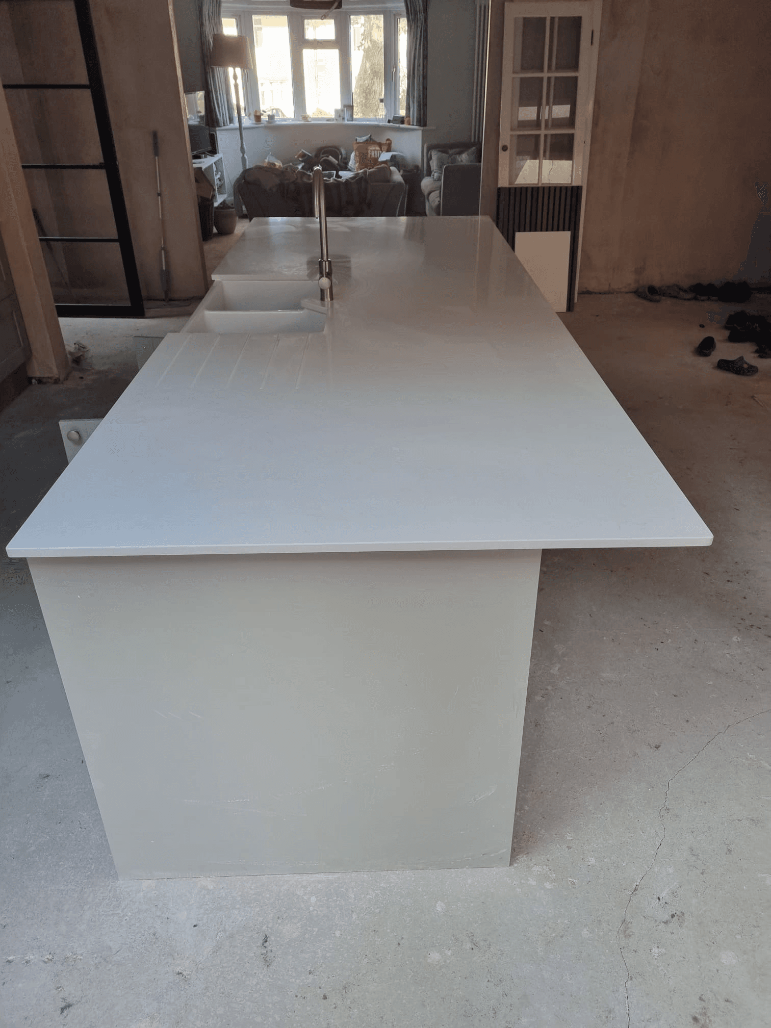 Large white quartz kitchen island worktop fitted and ready for finishing