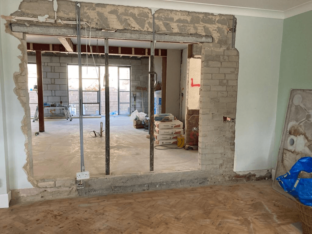 Wide knock-through opening in progress — RSJ beams installed above new open-plan space