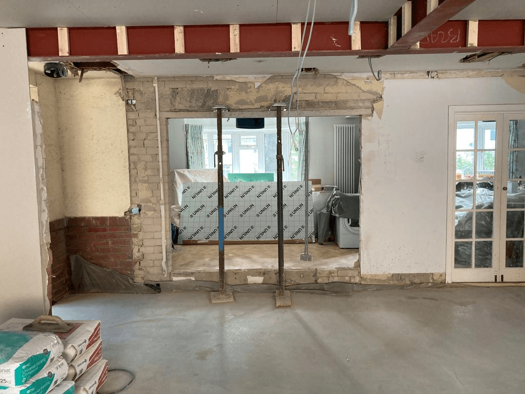 Structural props supporting wall during knock-through — opening up between rooms