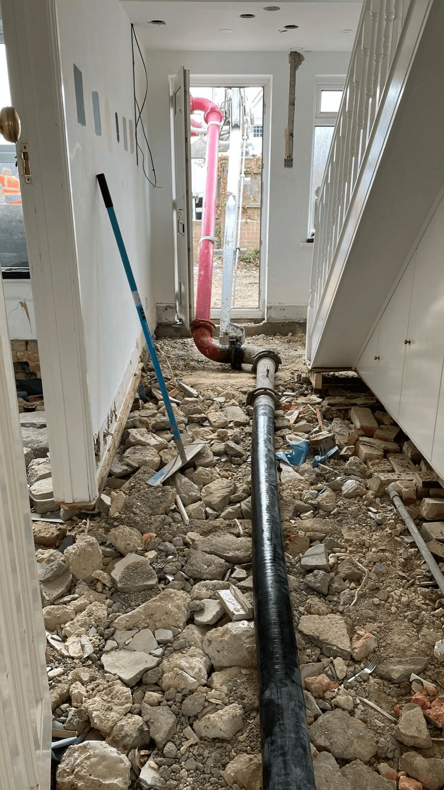 New drainage pipework laid under hallway floor during refurbishment
