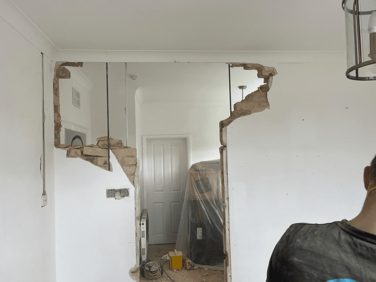 Wall removal in progress — opening up between rooms