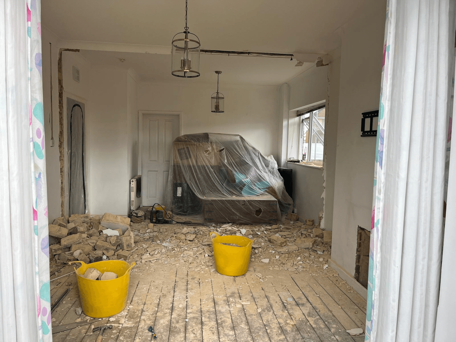 After wall removal — cleared space ready for structural beam installation